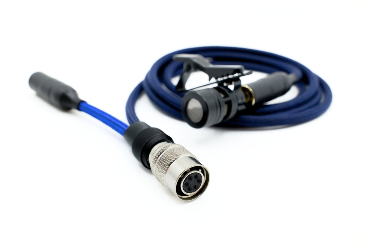Close-up of Bolero talkback adapter showing the locking Hirose-style connector end of a blue cable, with a clip-on lavalier microphone in the background